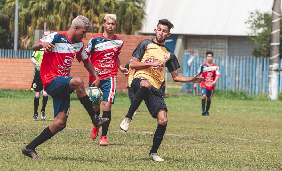 Dois atletas dividem a bola no futebol